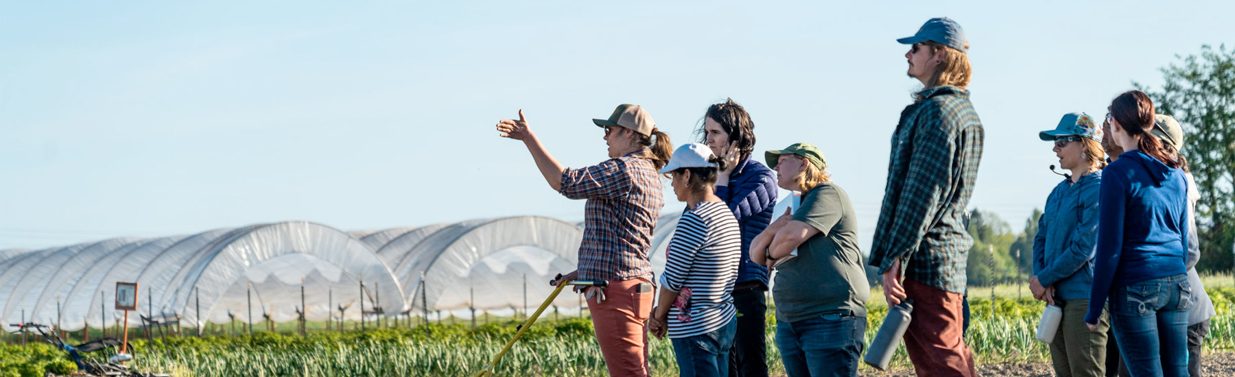 Agriculture faculty showing students how to use the seeder