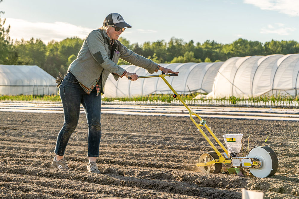 Agriculture student using a seeder for the first time.